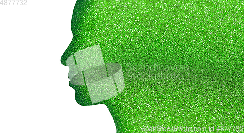 Image of silhouette of woman face on green glitters