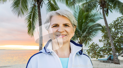 Image of smiling sporty senior woman at summer park