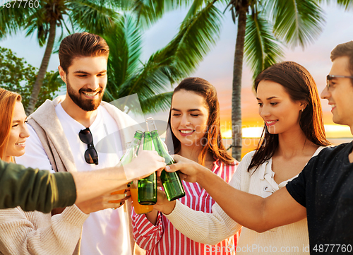 Image of friends toasting non alcoholic drinks on beach
