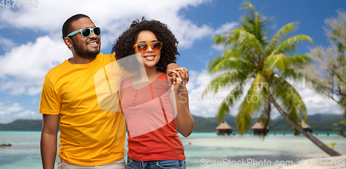 Image of happy african american couple in sunglasses