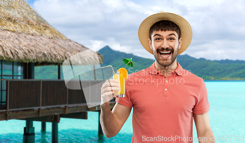 Image of happy man in straw hat with orange juice cocktail