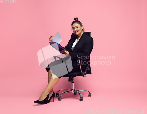 Image of Young caucasian woman in office attire. Bodypositive female character. plus size businesswoman