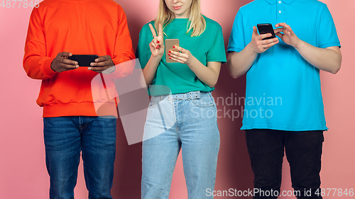 Image of Group of friends using mobile smartphones. Teenagers addiction to new technology trends. Close up.