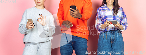 Image of Group of friends using mobile smartphones. Teenagers addiction to new technology trends. Close up.