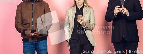 Image of Group of friends using mobile smartphones. Teenagers addiction to new technology trends. Close up.