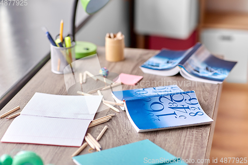 Image of school supplies scattered on table at home