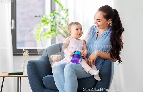 Image of happy mother with little baby daughter at home