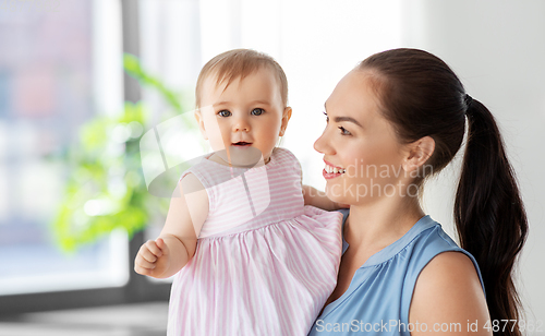 Image of happy mother with little baby daughter at home