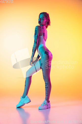 Image of Portrait of young caucasian woman on gradient yellow background with copyspace, unusual and freaky appearance