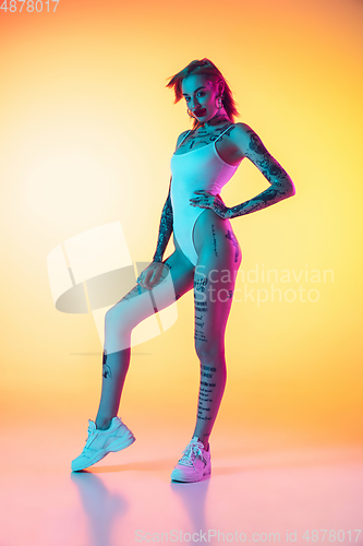 Image of Portrait of young caucasian woman on gradient yellow background with copyspace, unusual and freaky appearance