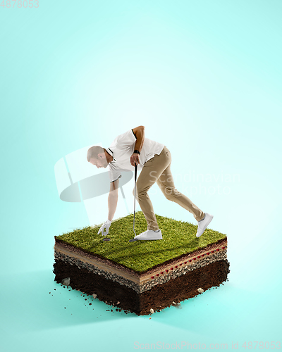 Image of Golf player in a white shirt playing on blue background above stadium layers. Professional player practicing during gameplay, championship