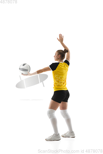 Image of Young female volleyball player isolated on white studio background. Woman in sport\'s equipment training and practicing.