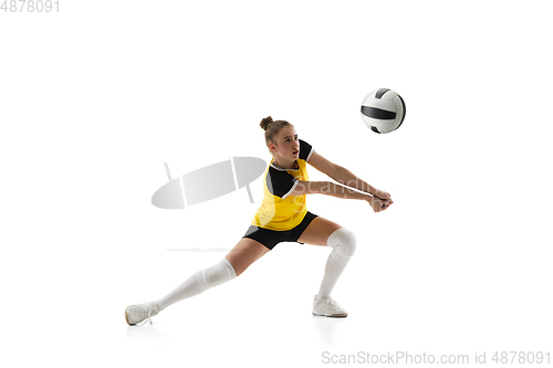 Image of Young female volleyball player isolated on white studio background. Woman in sport\'s equipment training and practicing.