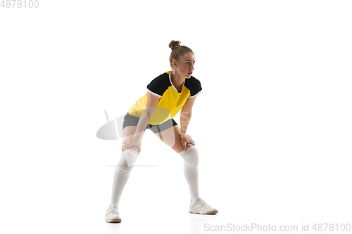 Image of Young female volleyball player isolated on white studio background. Woman in sport\'s equipment training and practicing.