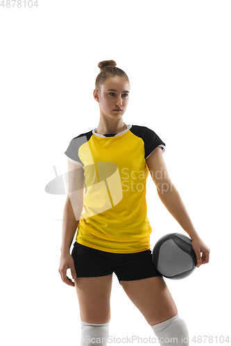 Image of Young female volleyball player isolated on white studio background. Woman in sport\'s equipment training and practicing.