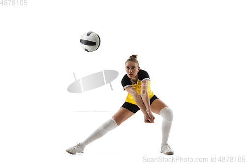 Image of Young female volleyball player isolated on white studio background. Woman in sport\'s equipment training and practicing.