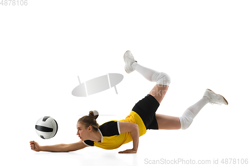 Image of Young female volleyball player isolated on white studio background. Woman in sport\'s equipment training and practicing.