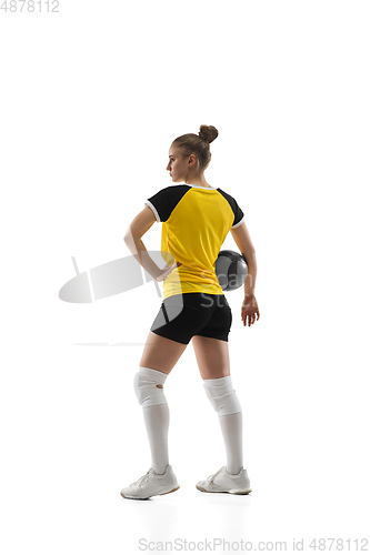 Image of Young female volleyball player isolated on white studio background. Woman in sport\'s equipment training and practicing.