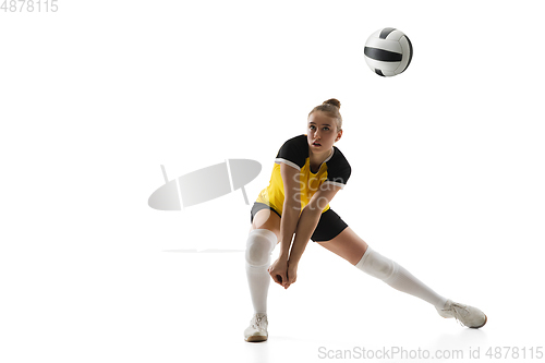 Image of Young female volleyball player isolated on white studio background. Woman in sport\'s equipment training and practicing.