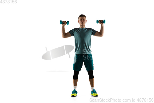 Image of Young caucasian male model in action, motion isolated on white background. Concept of sport, movement, energy and dynamic, healthy lifestyle. Training, practicing.