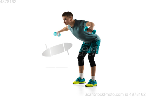 Image of Young caucasian male model in action, motion isolated on white background. Concept of sport, movement, energy and dynamic, healthy lifestyle. Training, practicing.