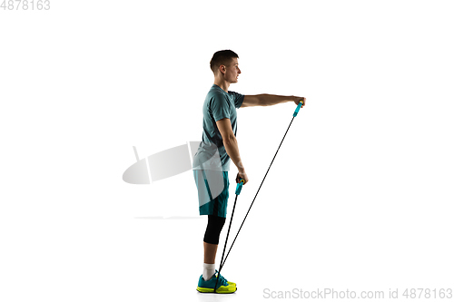 Image of Young caucasian male model in action, motion isolated on white background. Concept of sport, movement, energy and dynamic, healthy lifestyle. Training, practicing.