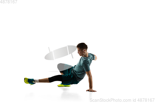 Image of Young caucasian male model in action, motion isolated on white background. Concept of sport, movement, energy and dynamic, healthy lifestyle. Training, practicing.