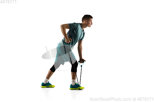 Image of Young caucasian male model in action, motion isolated on white background. Concept of sport, movement, energy and dynamic, healthy lifestyle. Training, practicing.