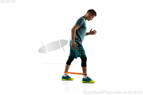 Image of Young caucasian male model in action, motion isolated on white background. Concept of sport, movement, energy and dynamic, healthy lifestyle. Training, practicing.