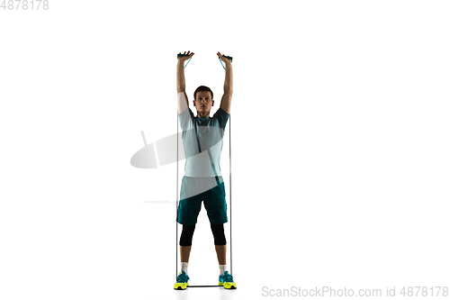 Image of Young caucasian male model in action, motion isolated on white background. Concept of sport, movement, energy and dynamic, healthy lifestyle. Training, practicing.