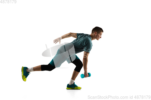 Image of Young caucasian male model in action, motion isolated on white background. Concept of sport, movement, energy and dynamic, healthy lifestyle. Training, practicing.