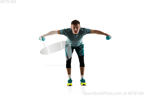 Image of Young caucasian male model in action, motion isolated on white background. Concept of sport, movement, energy and dynamic, healthy lifestyle. Training, practicing.