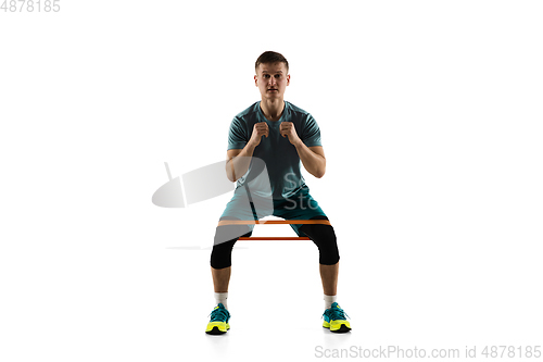 Image of Young caucasian male model in action, motion isolated on white background. Concept of sport, movement, energy and dynamic, healthy lifestyle. Training, practicing.