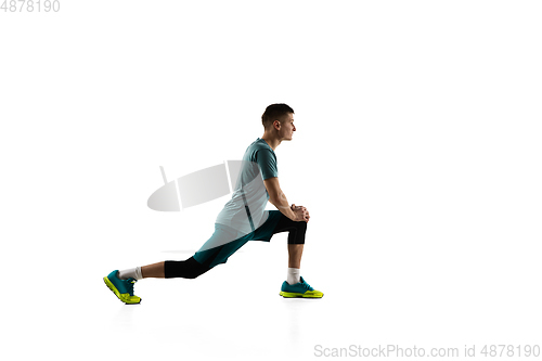 Image of Young caucasian male model in action, motion isolated on white background. Concept of sport, movement, energy and dynamic, healthy lifestyle. Training, practicing.