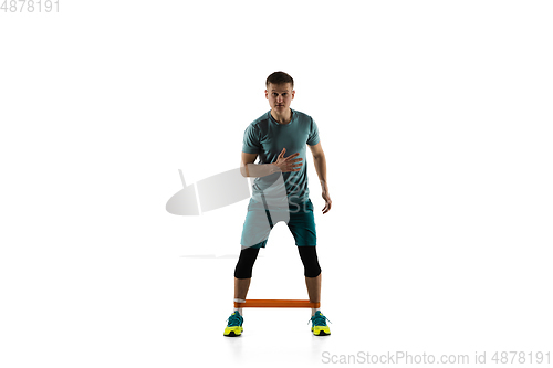 Image of Young caucasian male model in action, motion isolated on white background. Concept of sport, movement, energy and dynamic, healthy lifestyle. Training, practicing.