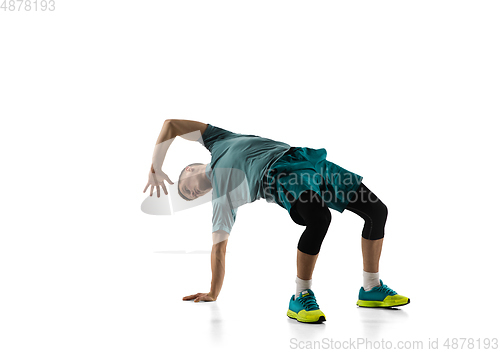 Image of Young caucasian male model in action, motion isolated on white background. Concept of sport, movement, energy and dynamic, healthy lifestyle. Training, practicing.