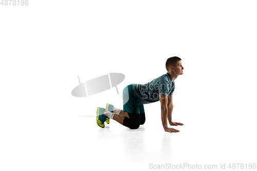 Image of Young caucasian male model in action, motion isolated on white background. Concept of sport, movement, energy and dynamic, healthy lifestyle. Training, practicing.