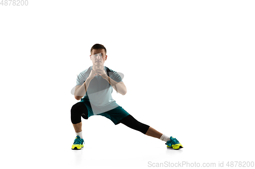 Image of Young caucasian male model in action, motion isolated on white background. Concept of sport, movement, energy and dynamic, healthy lifestyle. Training, practicing.