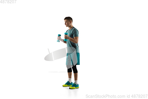 Image of Young caucasian male model in action, motion isolated on white background. Concept of sport, movement, energy and dynamic, healthy lifestyle. Training, practicing.