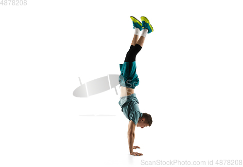 Image of Young caucasian male model in action, motion isolated on white background. Concept of sport, movement, energy and dynamic, healthy lifestyle. Training, practicing.