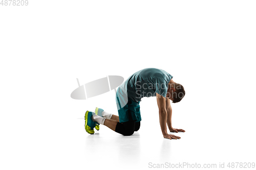 Image of Young caucasian male model in action, motion isolated on white background. Concept of sport, movement, energy and dynamic, healthy lifestyle. Training, practicing.