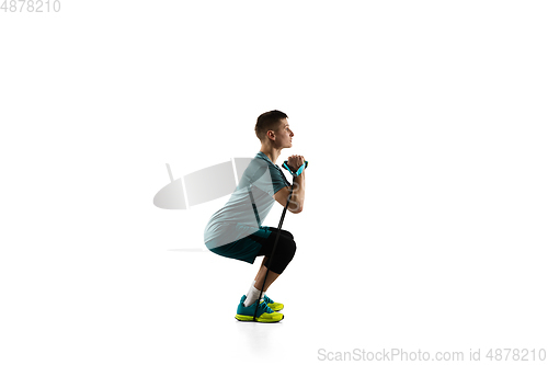 Image of Young caucasian male model in action, motion isolated on white background. Concept of sport, movement, energy and dynamic, healthy lifestyle. Training, practicing.