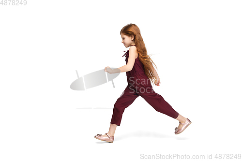 Image of Happy caucasian little girl isolated on white studio background. Looks happy, cheerful, sincere. Copyspace. Childhood, education, emotions concept