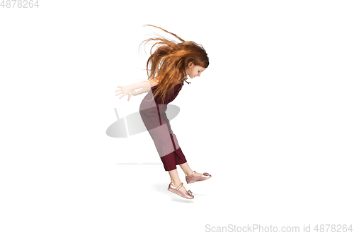 Image of Happy caucasian little girl isolated on white studio background. Looks happy, cheerful, sincere. Copyspace. Childhood, education, emotions concept