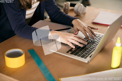 Image of Close up hands of girl typing during group video call, use video conference with teacher, listening to online course