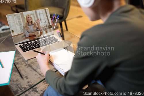 Image of Little boy studying by group video call, use video conference with teacher, listening to online course