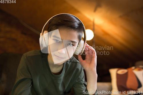 Image of Little boy wearing headphones during online education course, lesson, view of screen