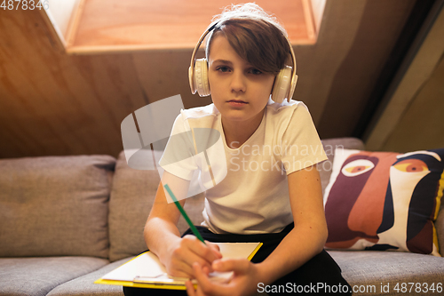 Image of Little boy view studying by group video call, use video conference with teacher, listening to online course