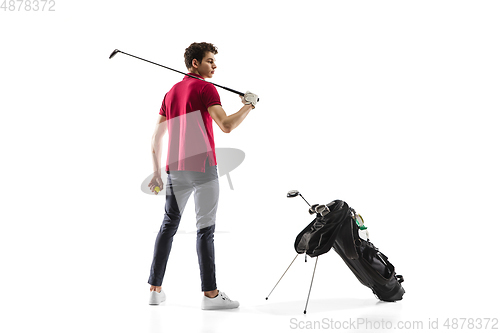 Image of Golf player in a red shirt training, practicing isolated on white studio background