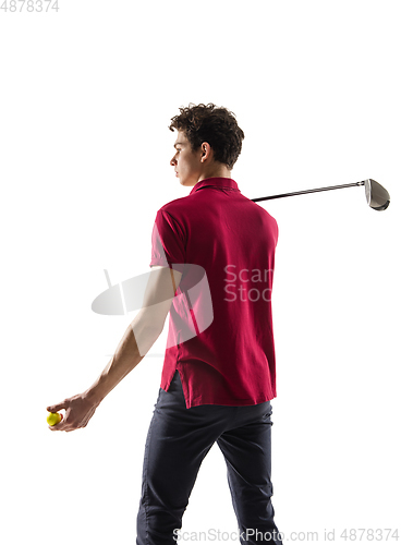 Image of Golf player in a red shirt training, practicing isolated on white studio background